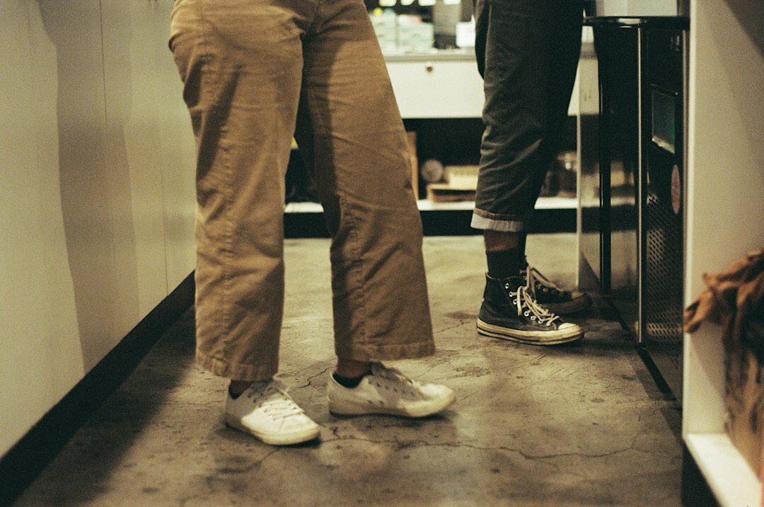 Two colleagues collaborating over a laptop in office